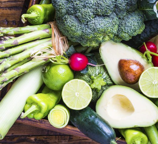 Organic vegetables on rustic dark wood background.Vegan food concept. Green veggies.